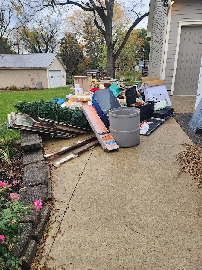 Dumpster being loaded with debris for Estate Cleanout Dumpster Rental in Elizabeth